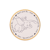Magic Tour Club ronde onderzetter met een illustratie van Dumbo en de tekst don't just fly... soar in goudkleur
